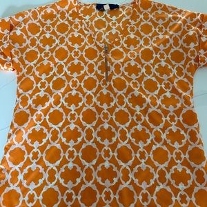 Orange and white patterned blouse